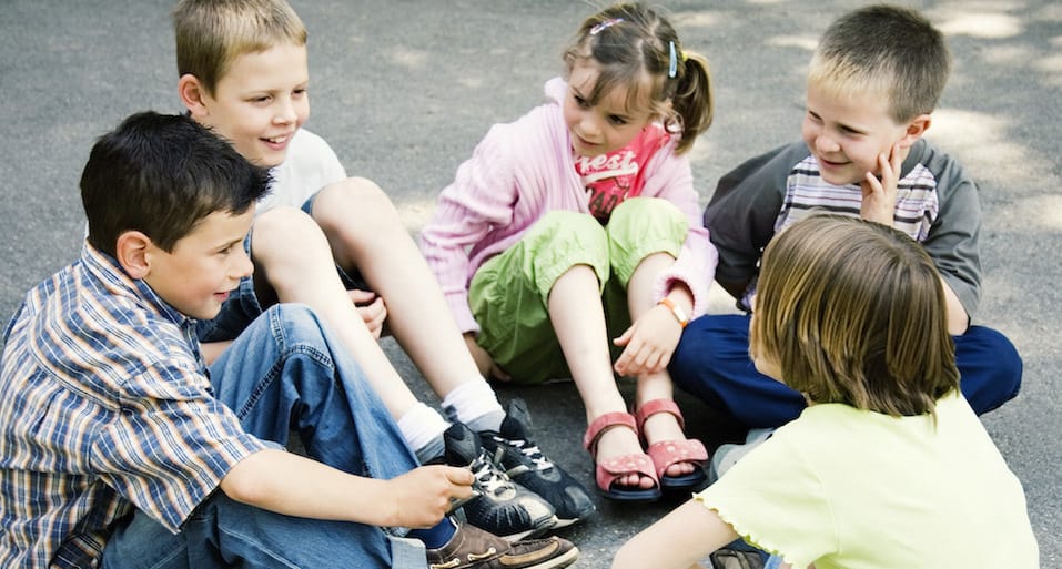 Children Sitting Together Outside