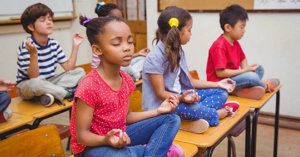 Students Meditating on Desks