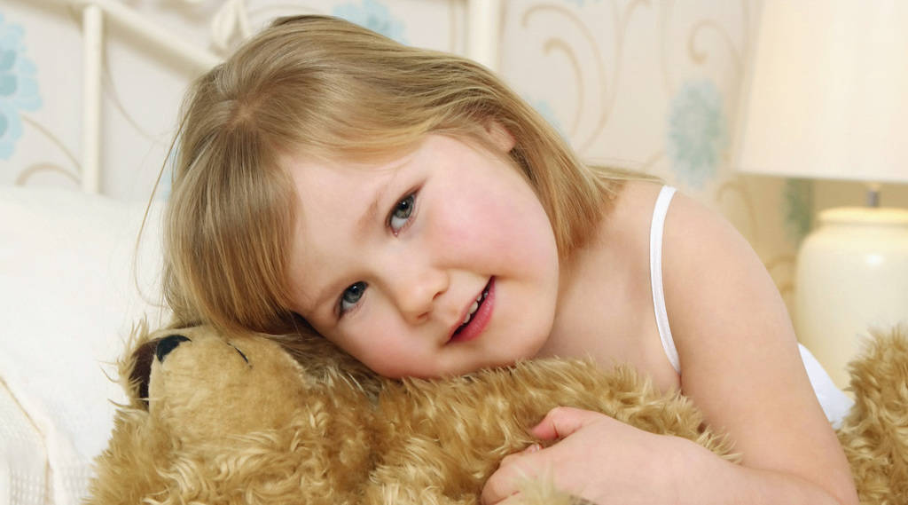 Child on Bed with Teddy Bear