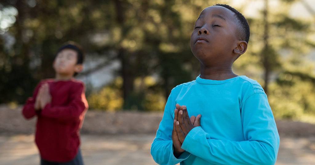 Children Meditating in Park