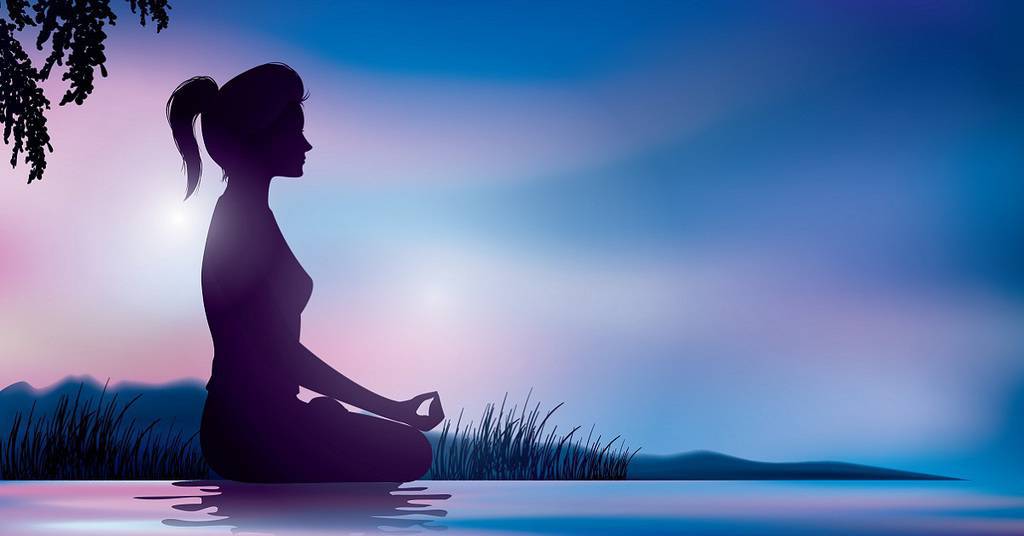 Woman Meditating on Beach