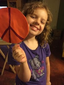 child with peace pop craft