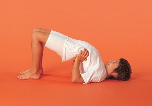 child in bridge pose