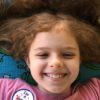 girl smiling on yoga mat