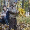 losing daylight - child playing in fall leaves